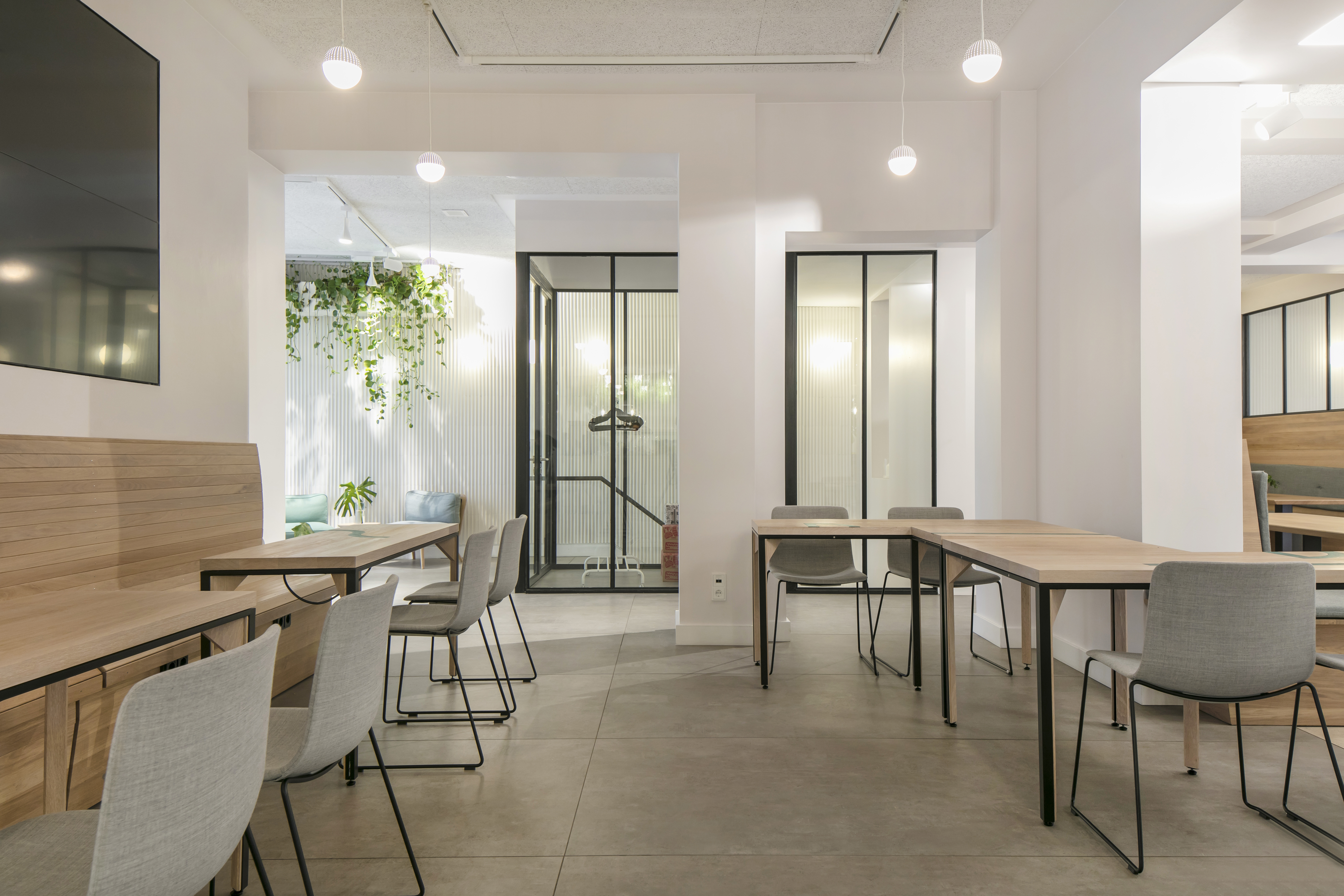 Bright, modern interior with grey floor tiles and wooden elements.
