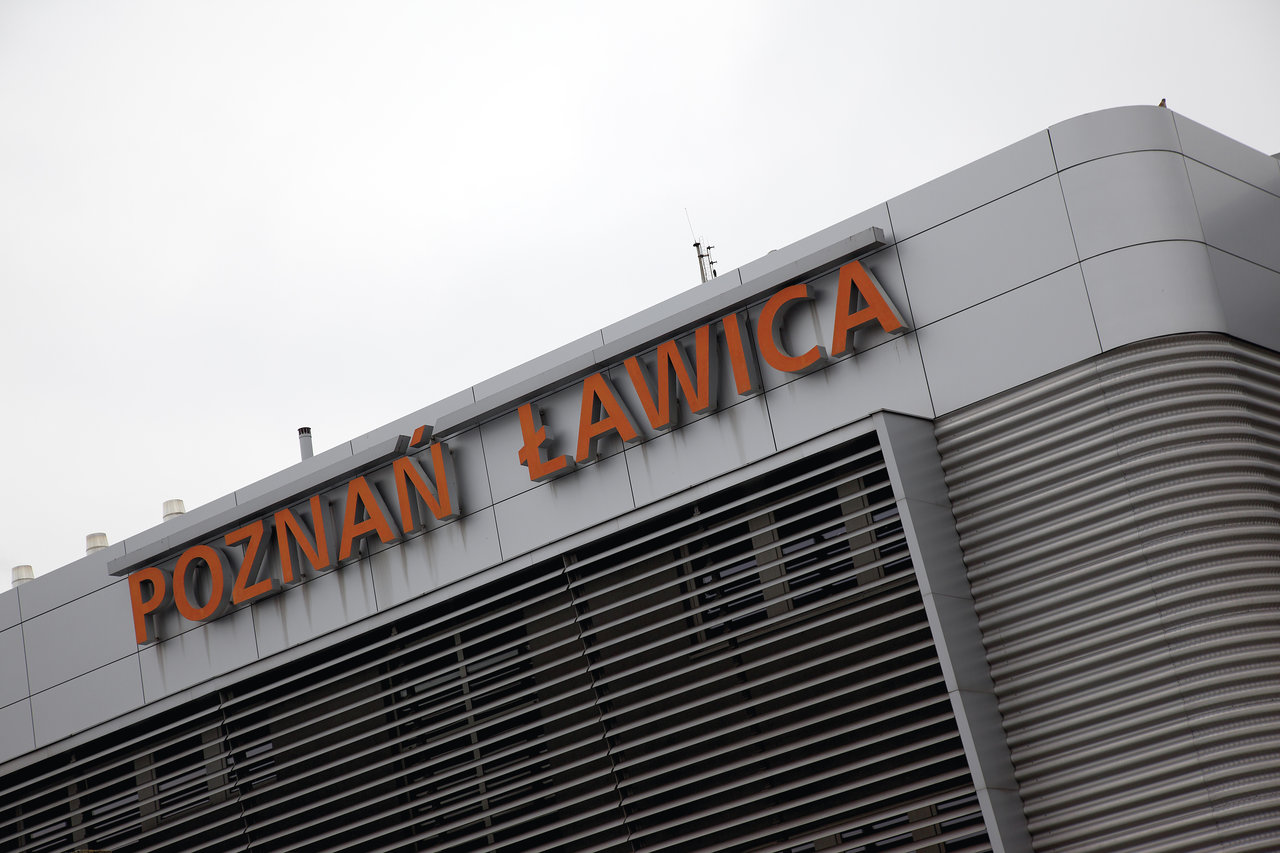 Modern building facade with 'POZNAŃ ŁAWICA' lettering.