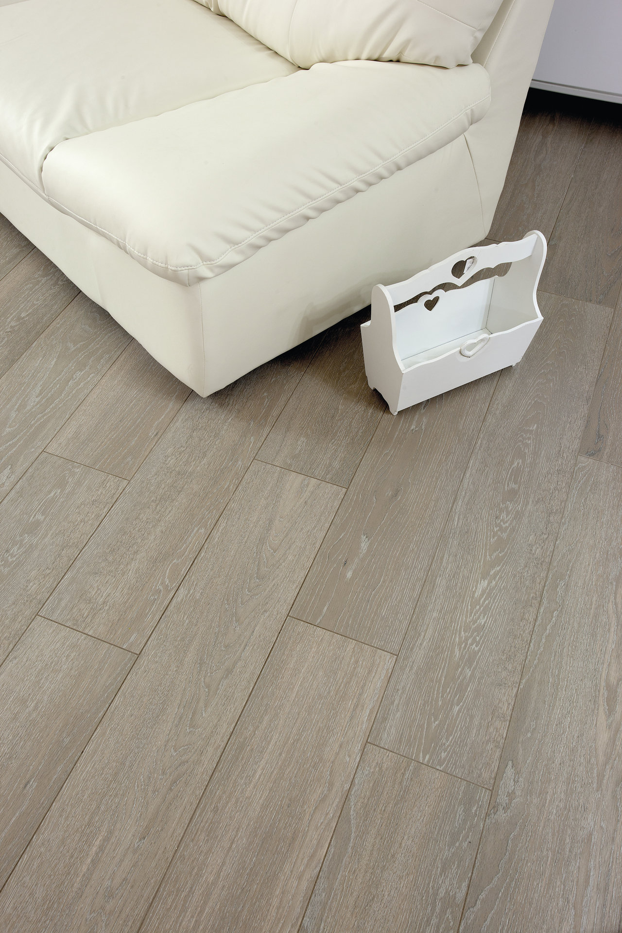 Light wood-look plank tiles, ideal for living areas.
