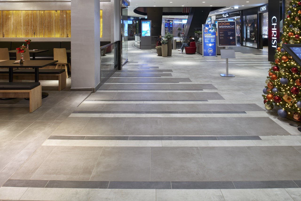Modern indoor tile design in grey tones with a stripe pattern.