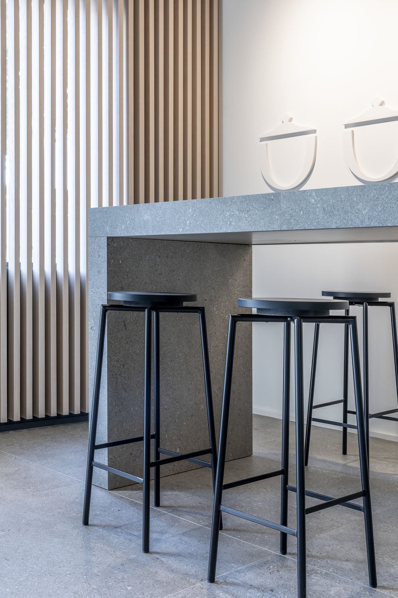 Modern room with grey concrete-look floor tiles and matching counter.