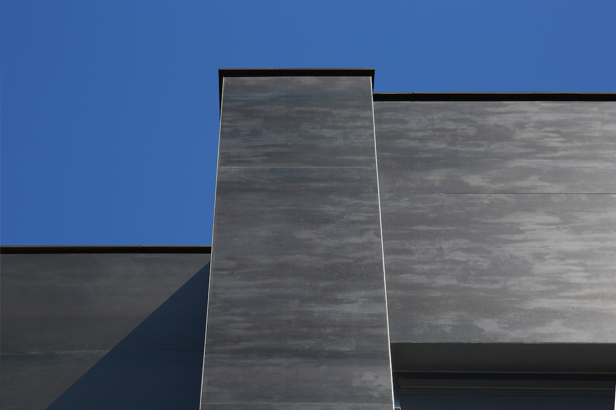 Architectural facade with high-quality, dark grey outdoor tiles.