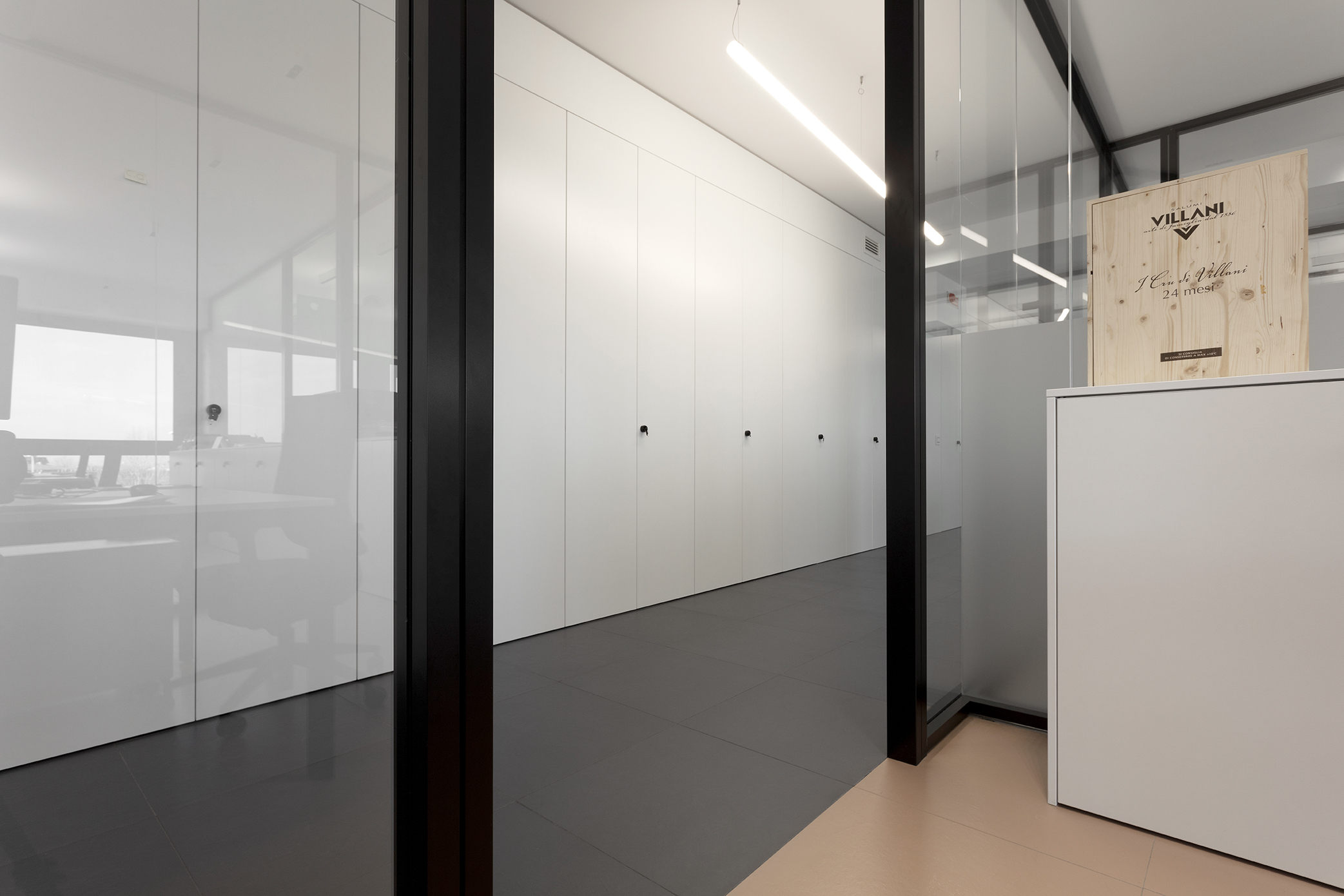 Elegant office design with contrasting anthracite and beige tile floors.