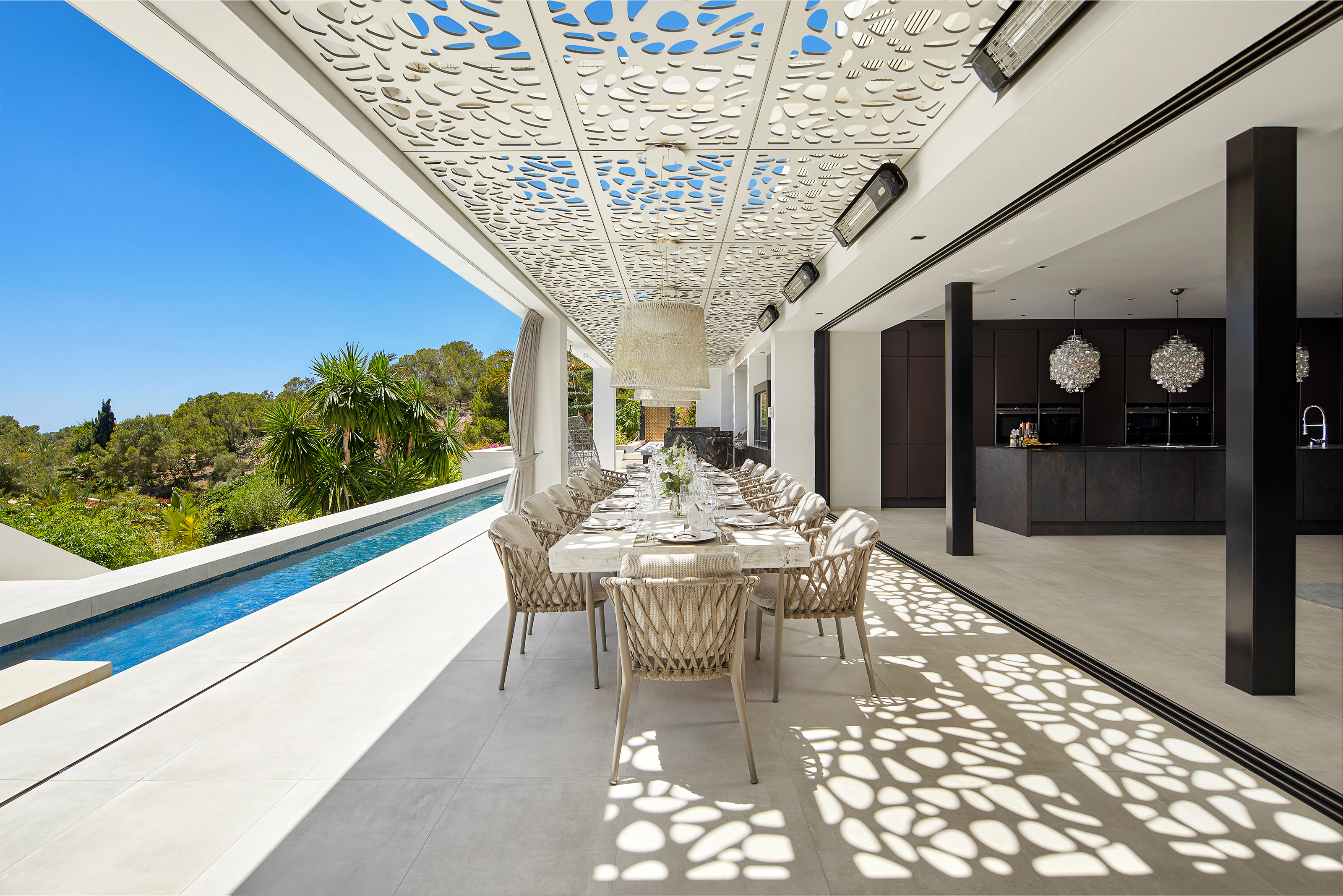 High-quality tiles seamlessly merge luxurious indoor and outdoor living, pool and dining.