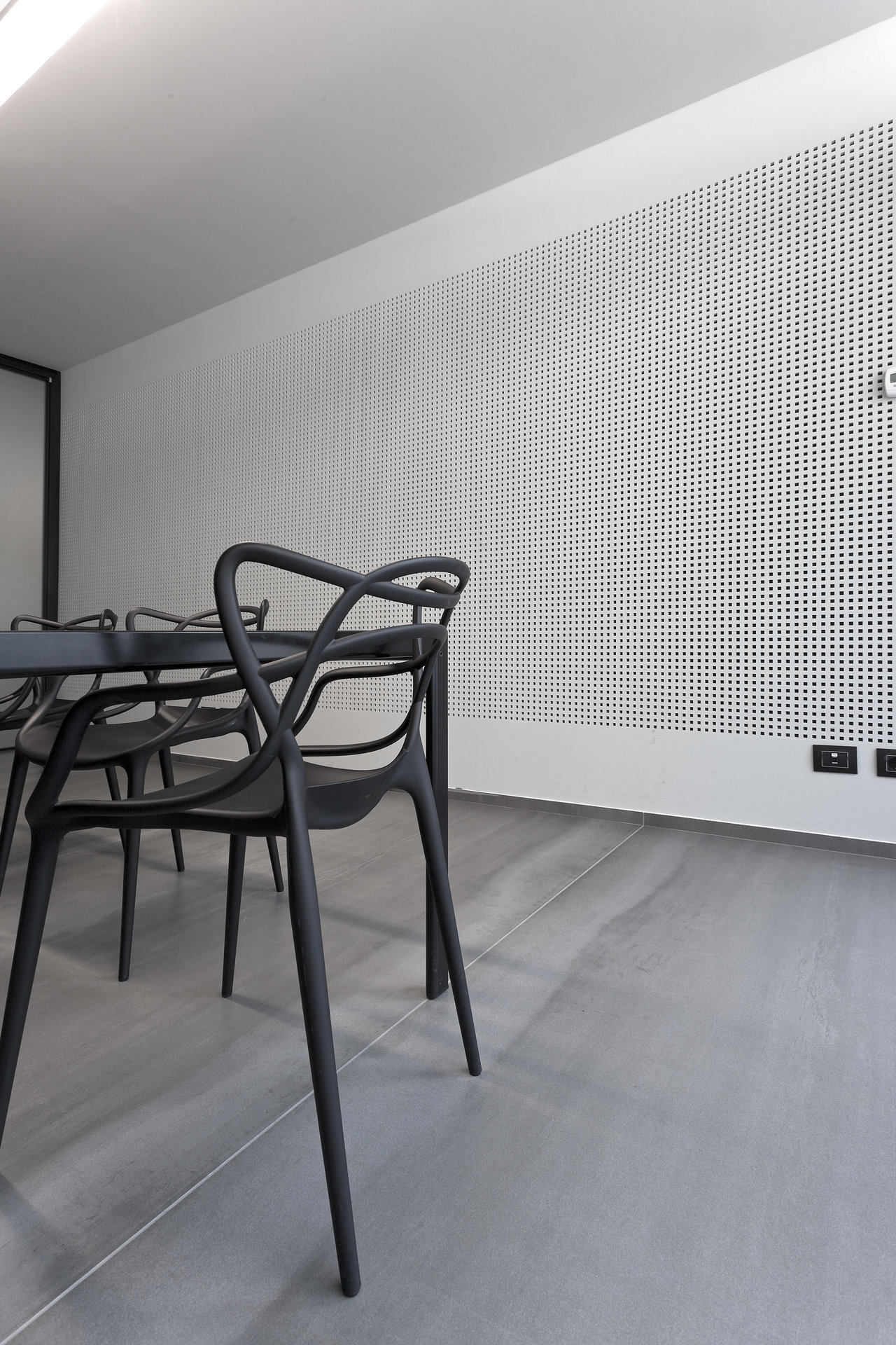 Large grey indoor tiles in a modern dining room.
