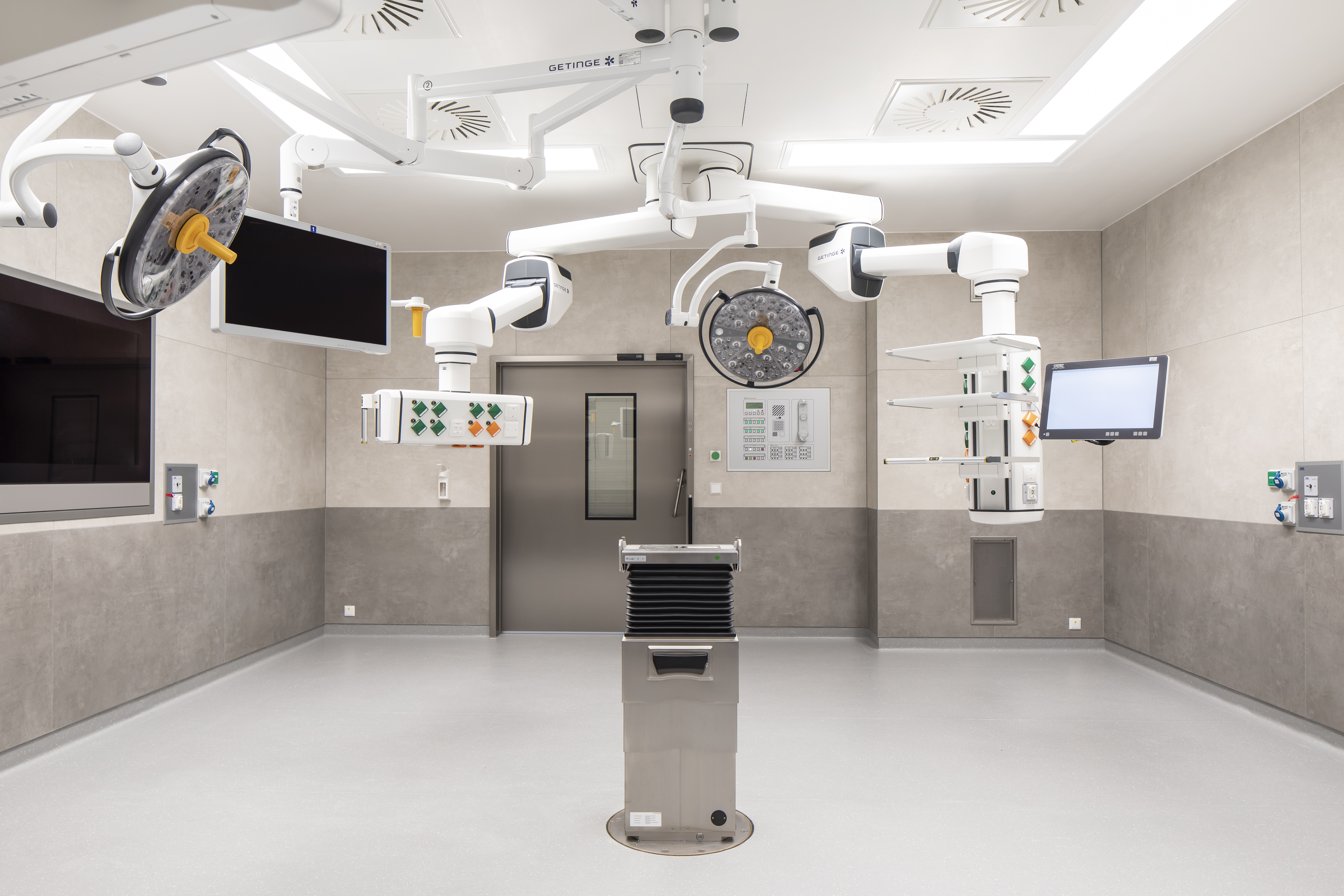 Hygienic grey wall and floor tiles in a modern operating room.