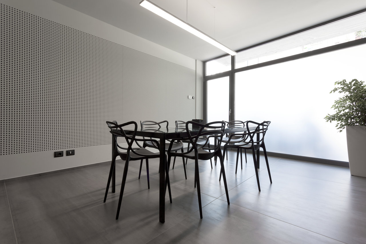 Modern grey floor tiles in a bright, minimalist room.