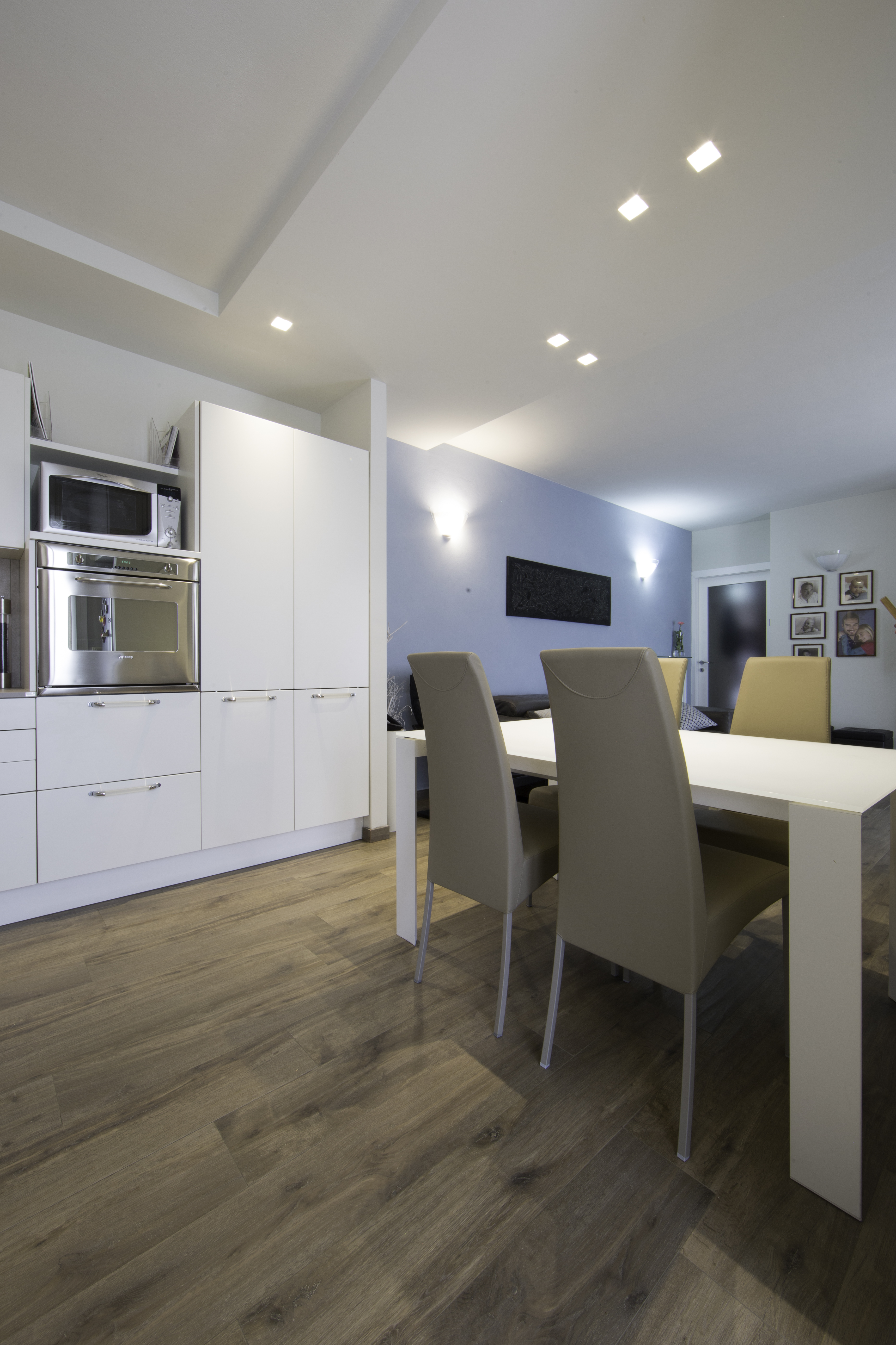 Wood-effect tiles in a modern kitchen and dining area.
