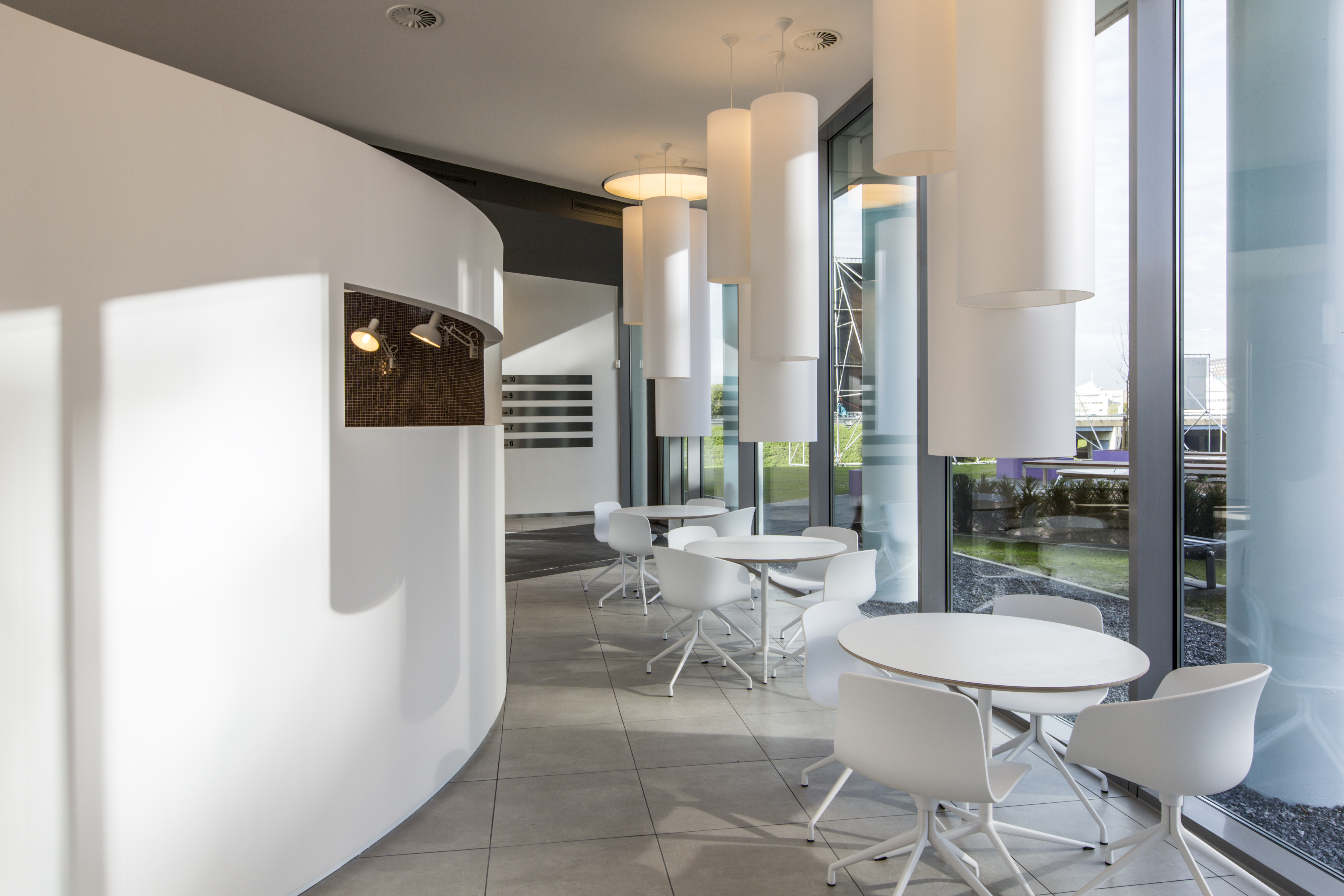 Modern lounge with light grey large format tiles and stylish interior.