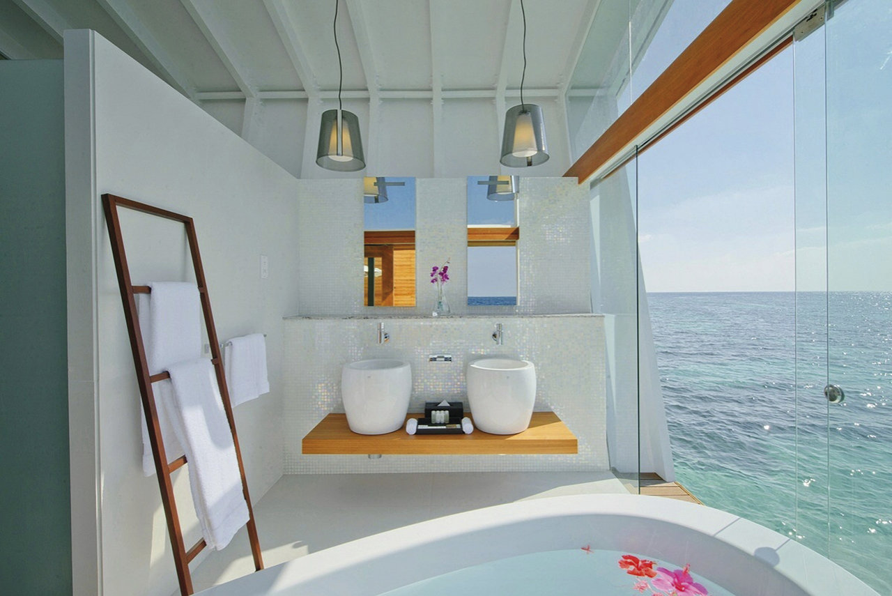 Exclusive bathroom with stylish tiles, designer basin, and panoramic sea view.