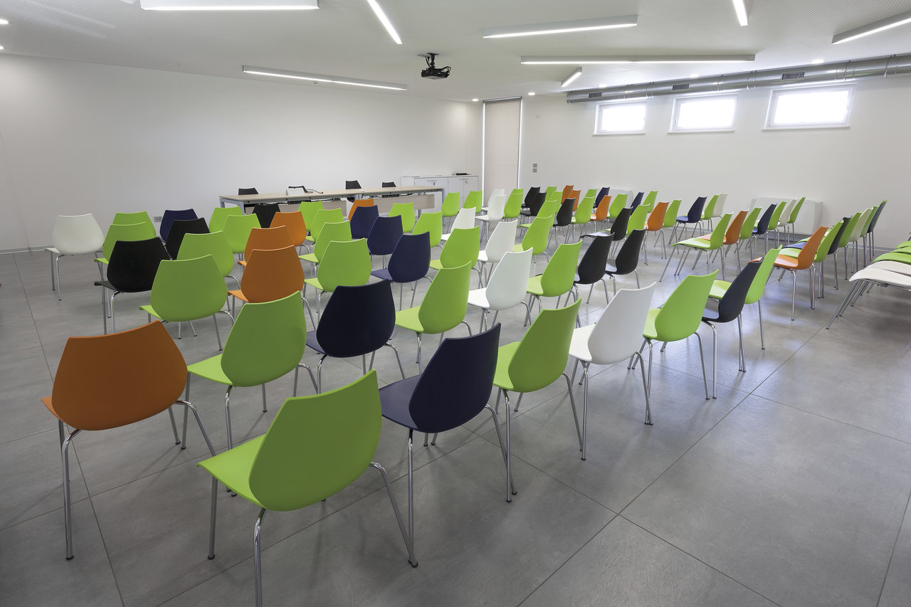 Modern conference room with large-format light grey tiles.