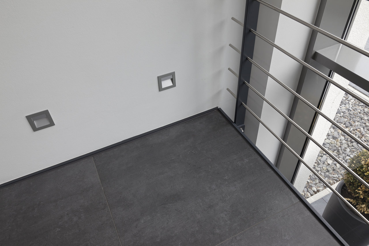 High-quality dark grey outdoor tiles on a modern balcony.