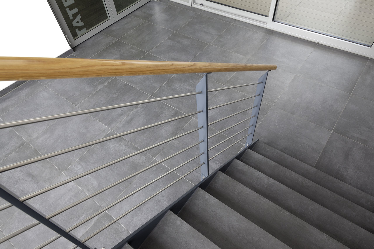 Modern grey concrete-effect tiles on stairs and landing.
