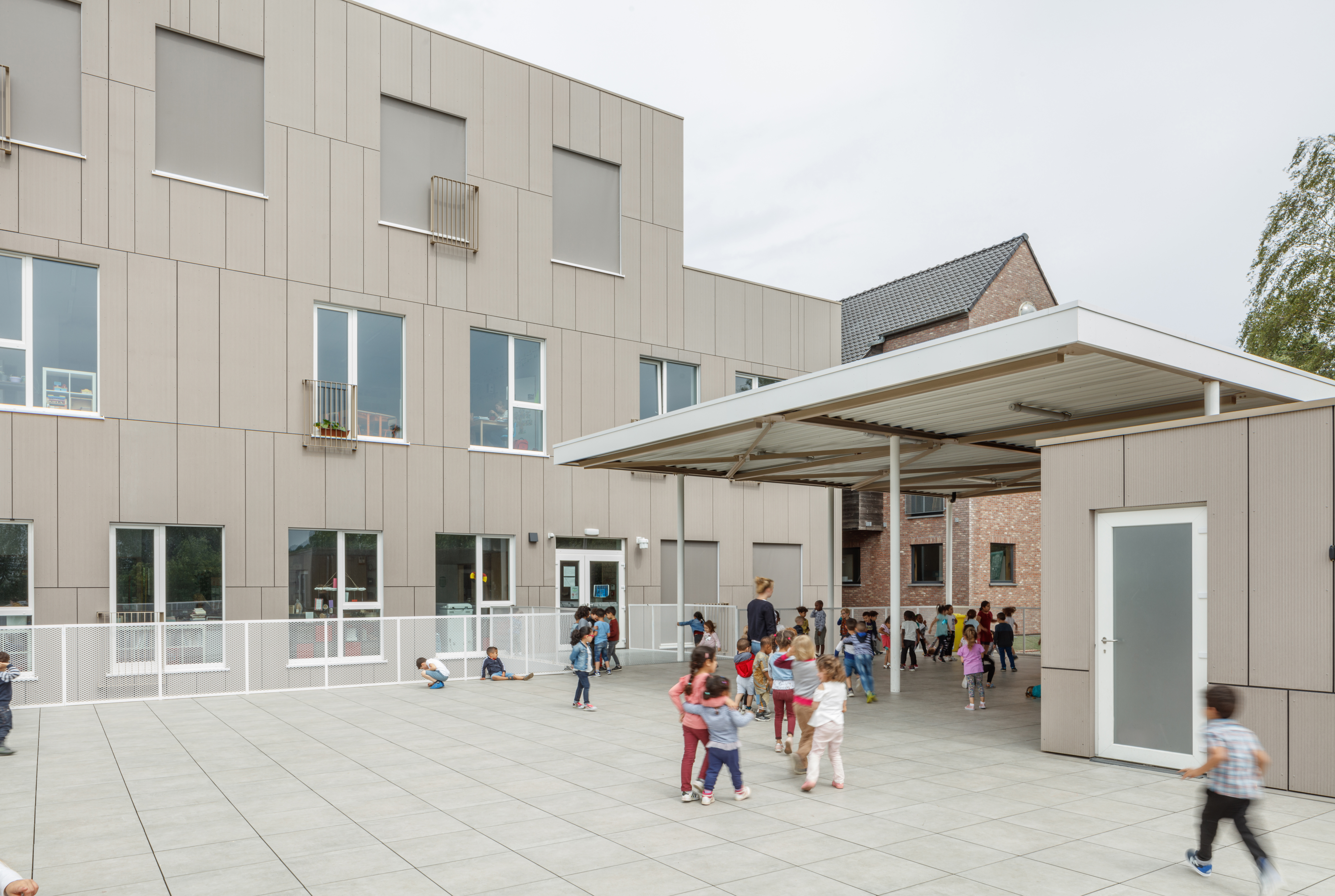 Robust outdoor tiles in a schoolyard, safe for children's play.