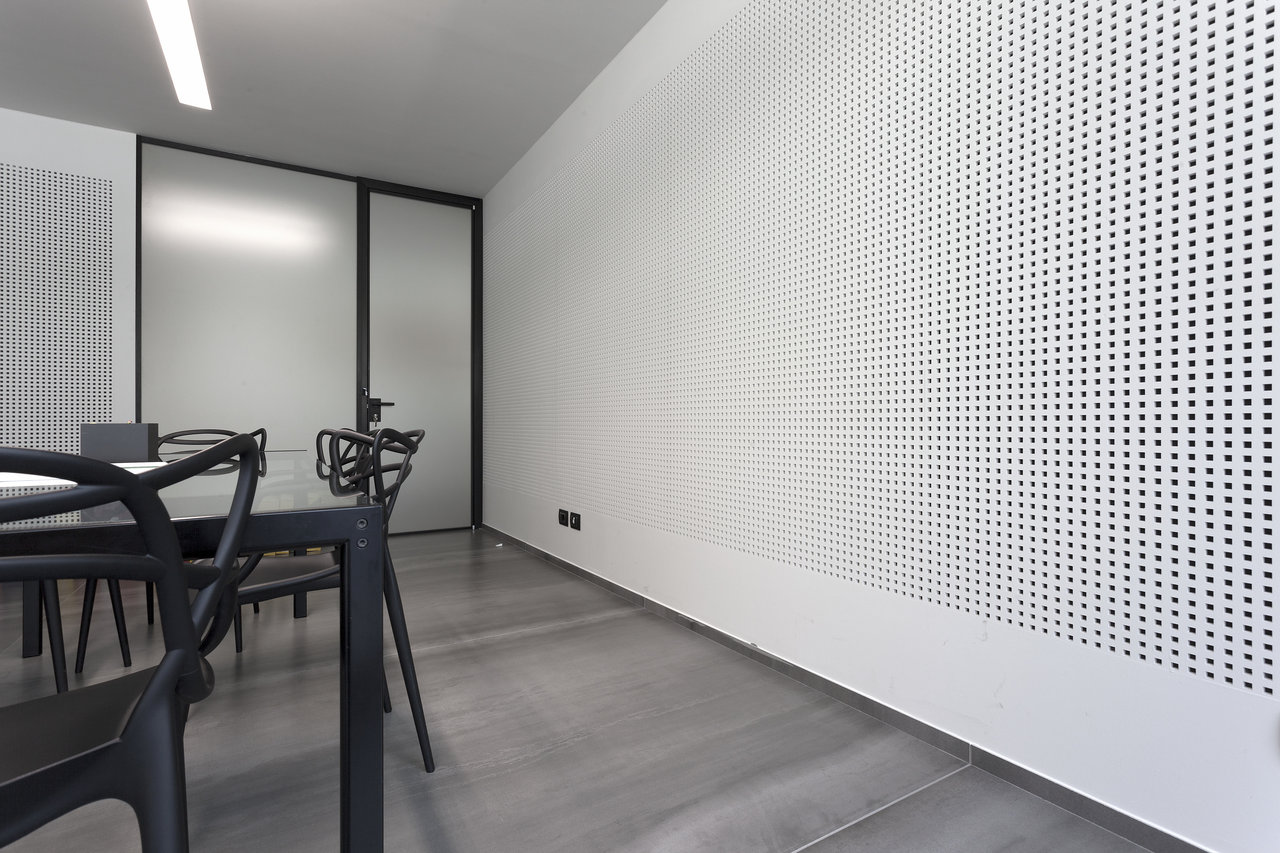 Modern grey large-format floor tiles in an office or meeting room.