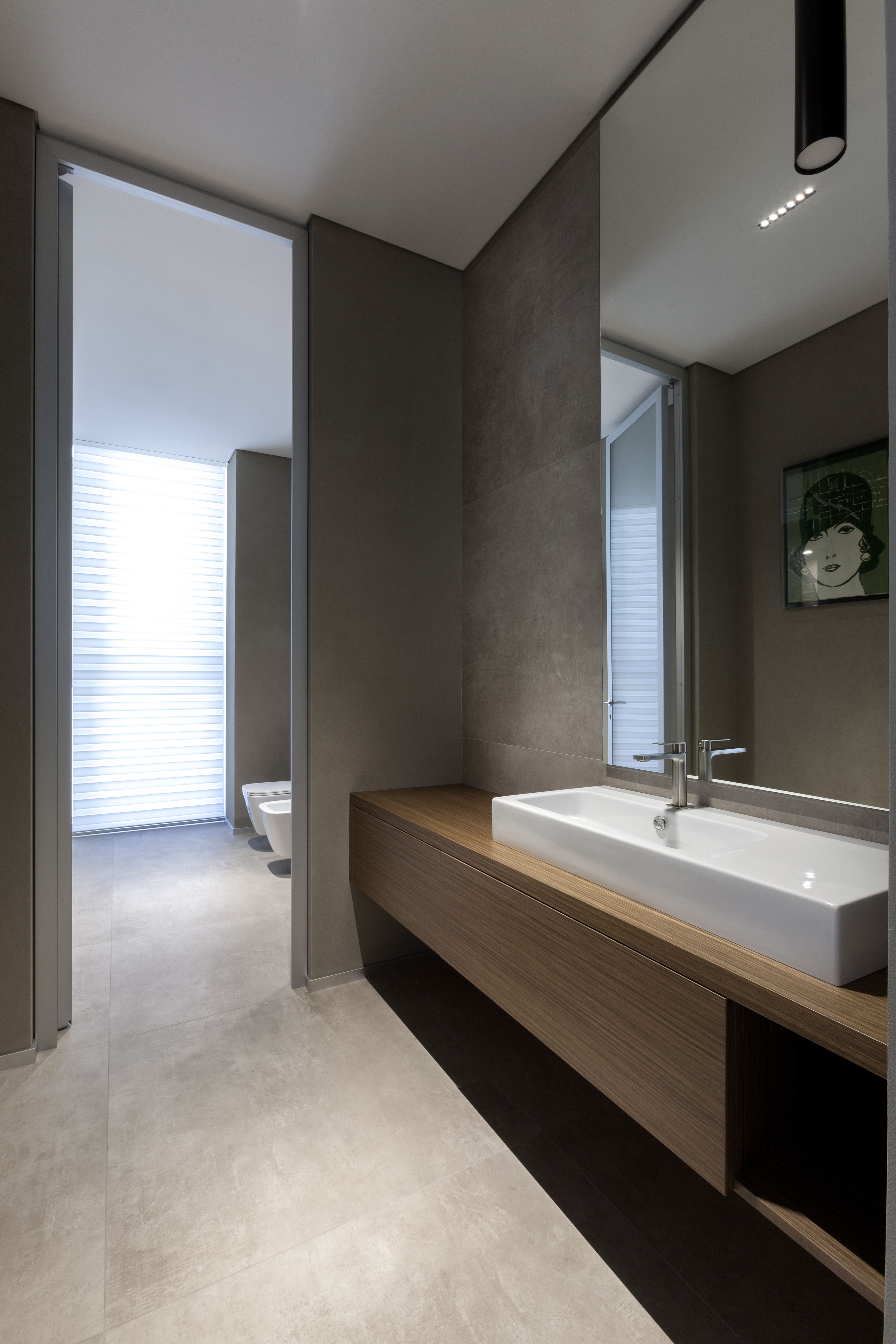 Timeless bathroom with grey porcelain stoneware tiles on floor and wall.