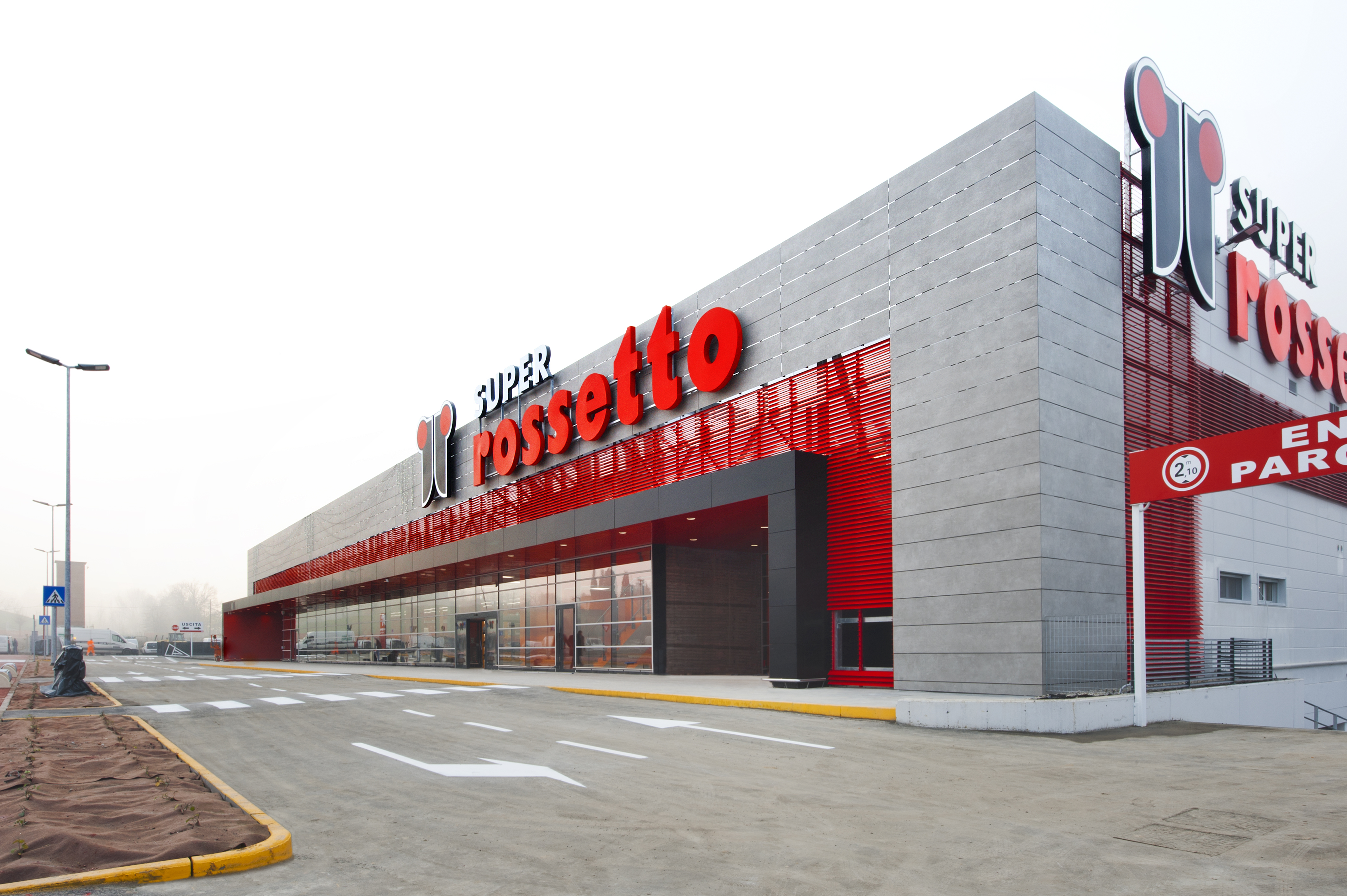 Modern Super Rossetto supermarket building with red logo.