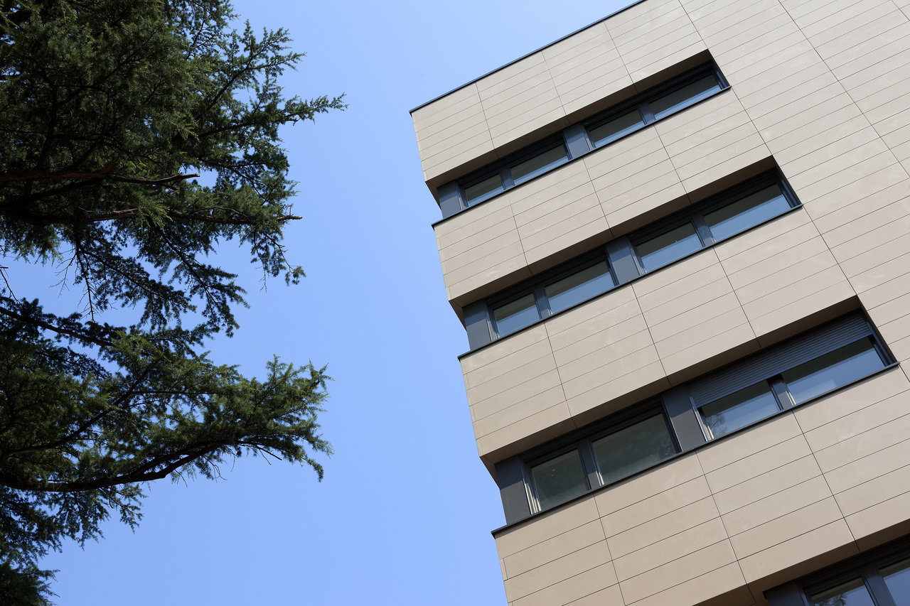 Modern building facade with beige outdoor tiles.