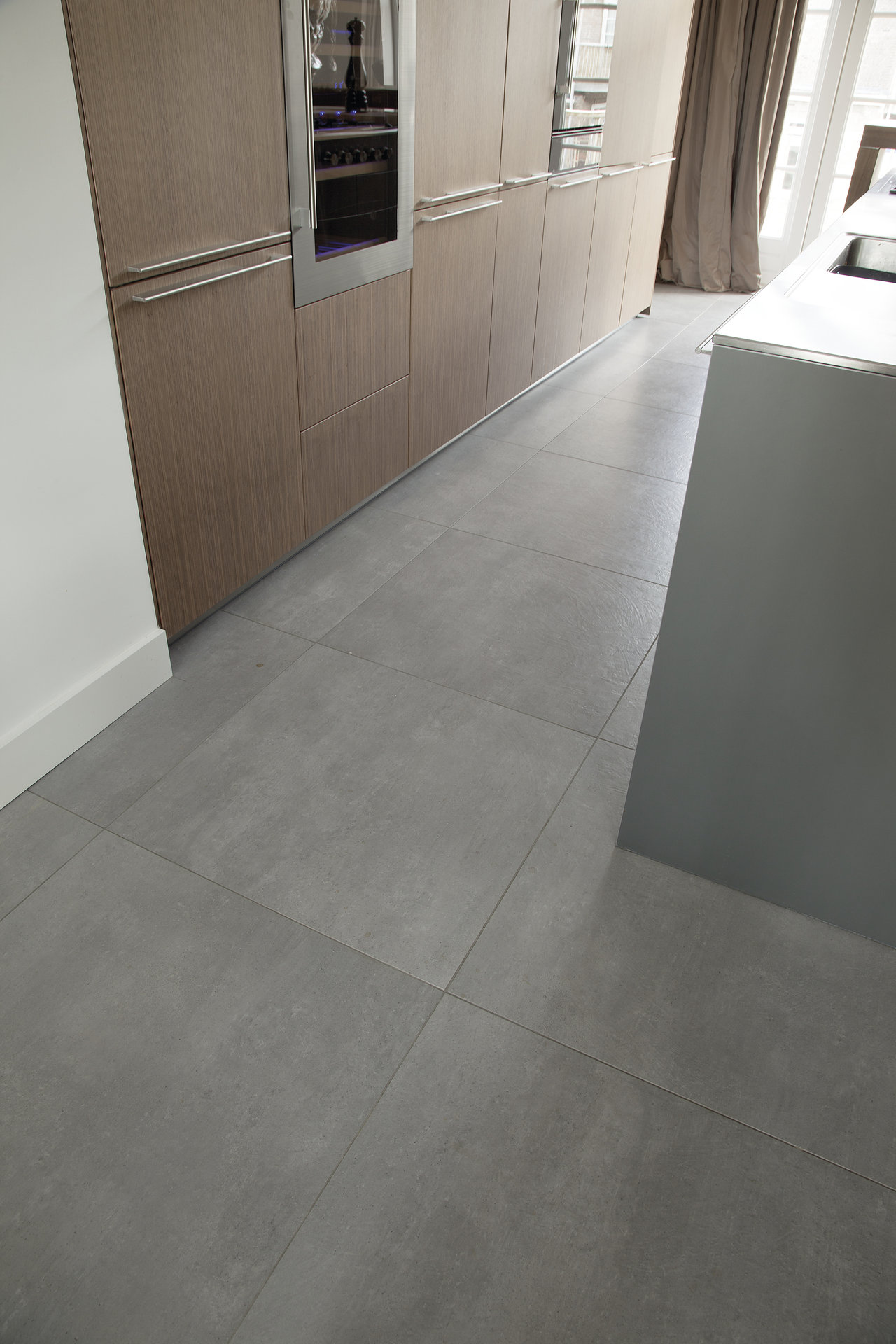 Premium grey concrete-effect porcelain tiles for modern kitchens & interiors.