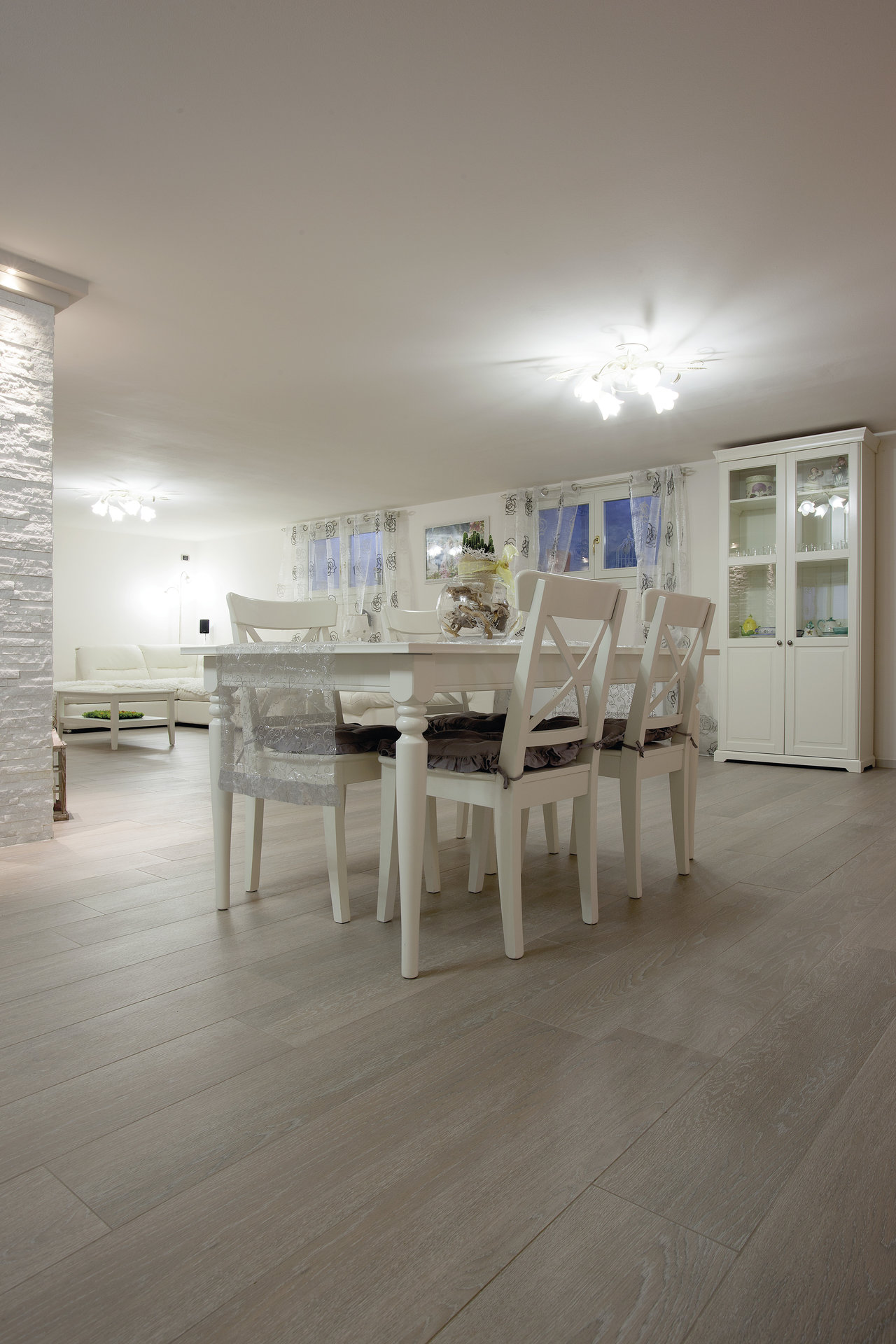 Light wood-effect tiles in living and dining area.