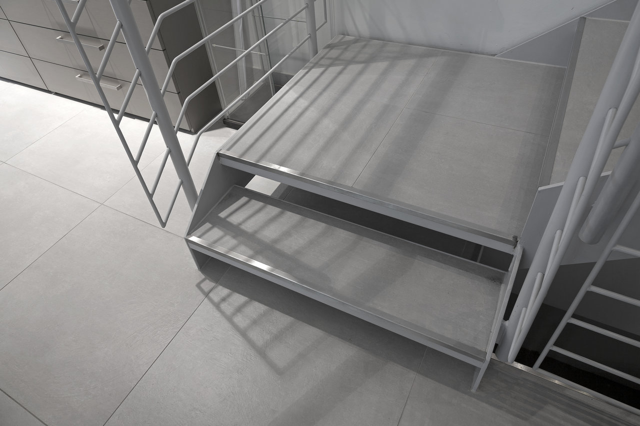 High-quality, light grey large format tiles in a modern interior.