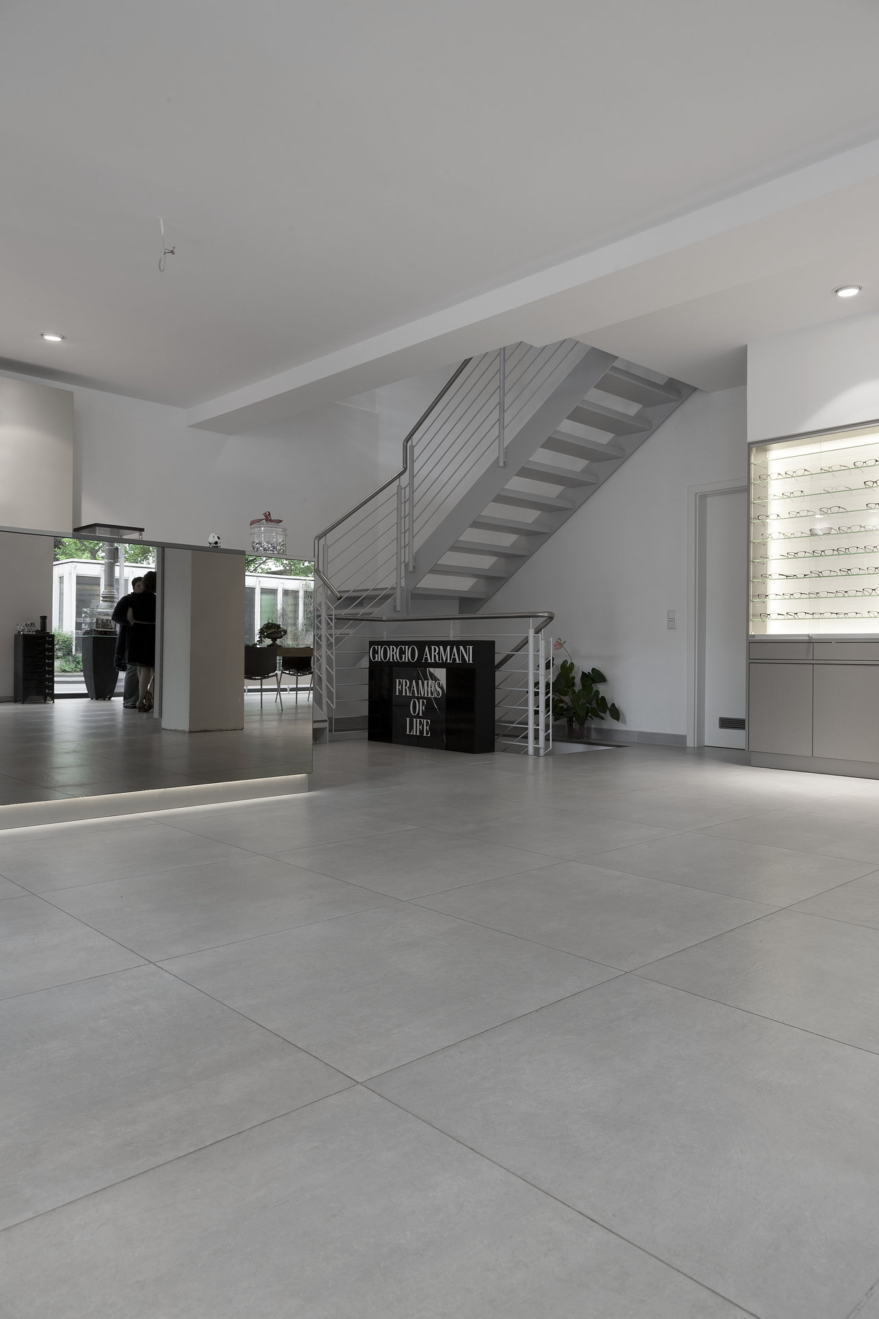 Elegant, large-format light grey floor tiles in a modern setting.