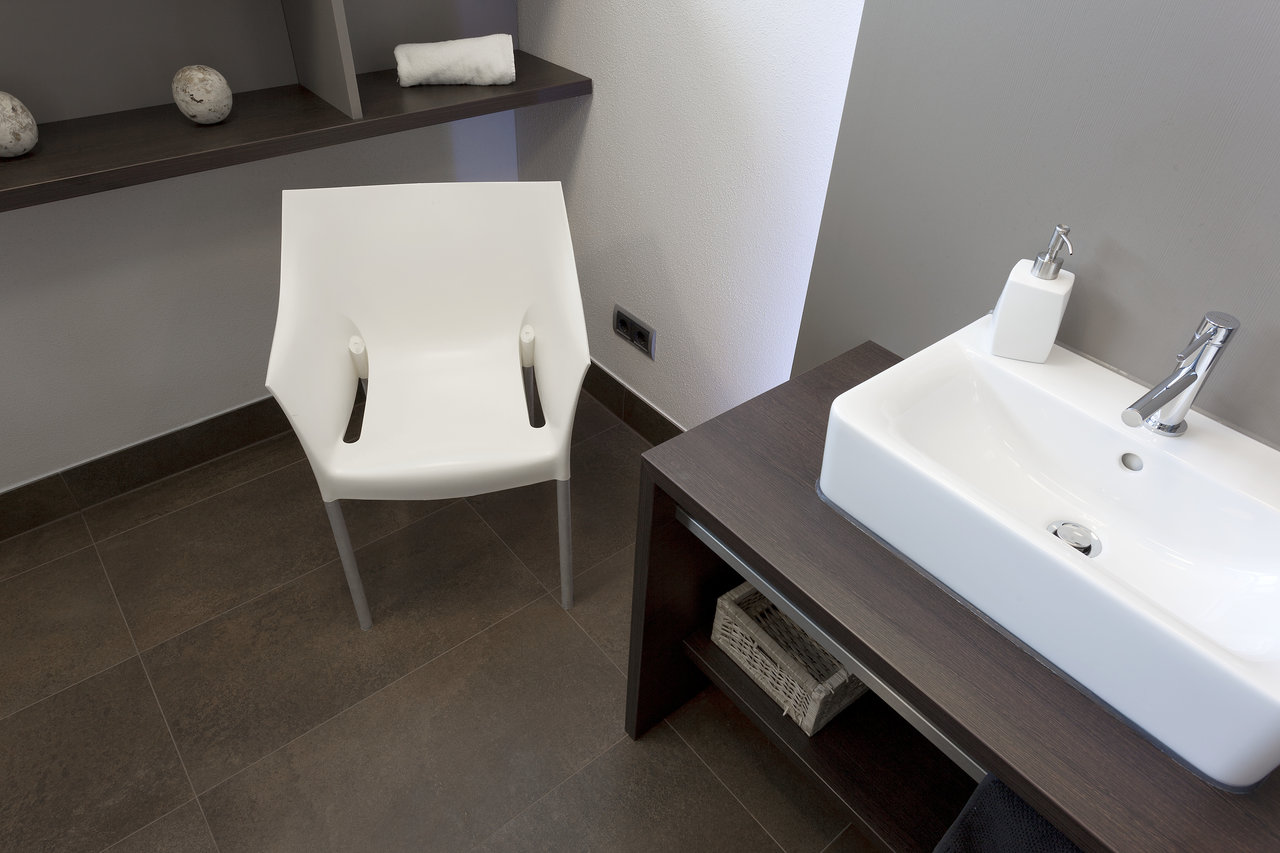 High-quality dark floor tiles in a modern bathroom.