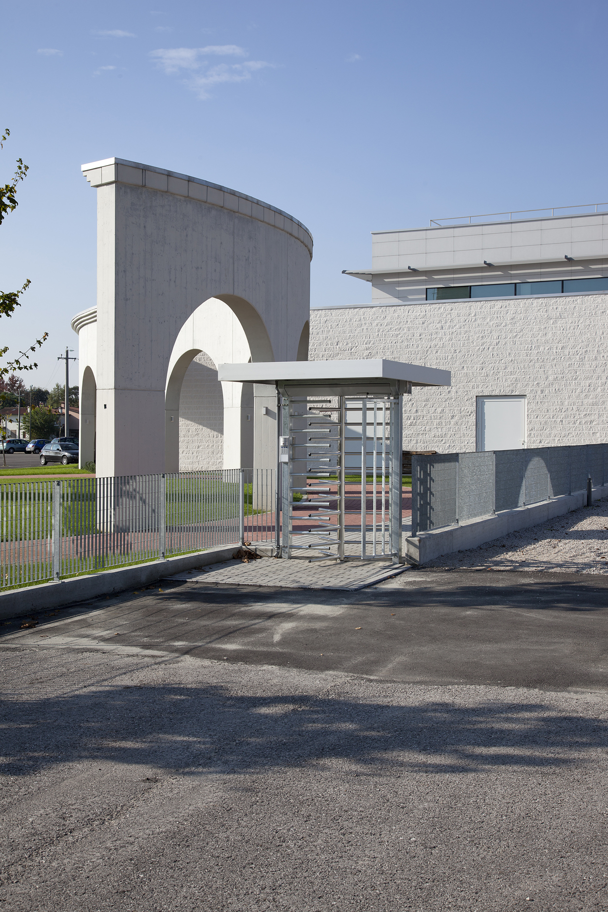 Modern entrance area with turnstile, striking arches, and high-quality tile flooring.