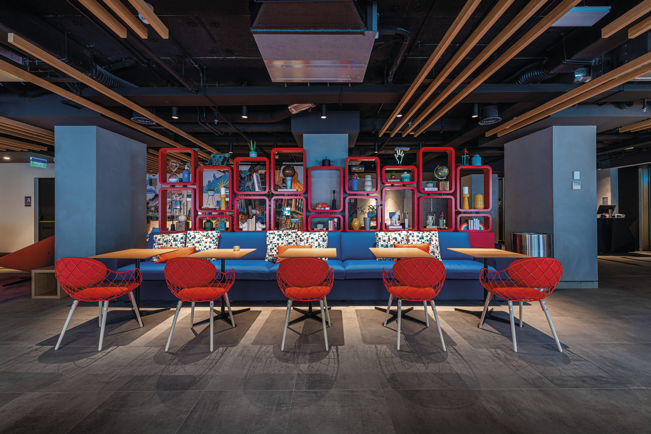 Dark tiles in a modern lounge area with blue and red accents.