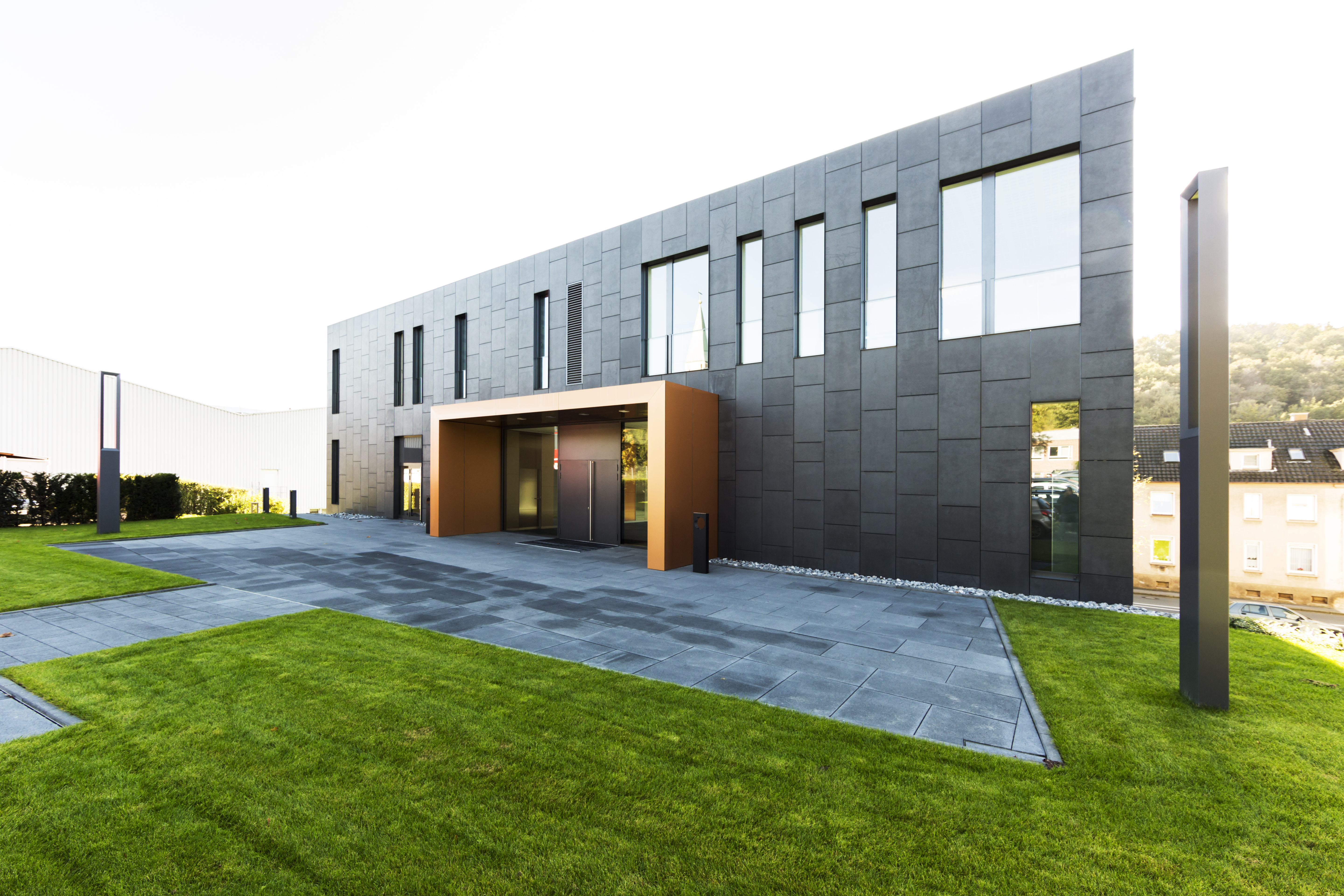 Modern building with high-quality tile facade and elegant outdoor paving.