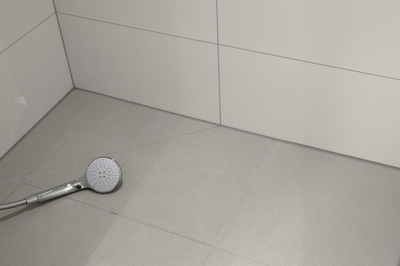 Modern grey tiles for floor and white for shower walls.