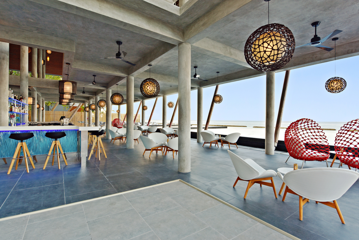 Stylish bar featuring premium grey tiles, seamlessly linking indoor and outdoor areas.