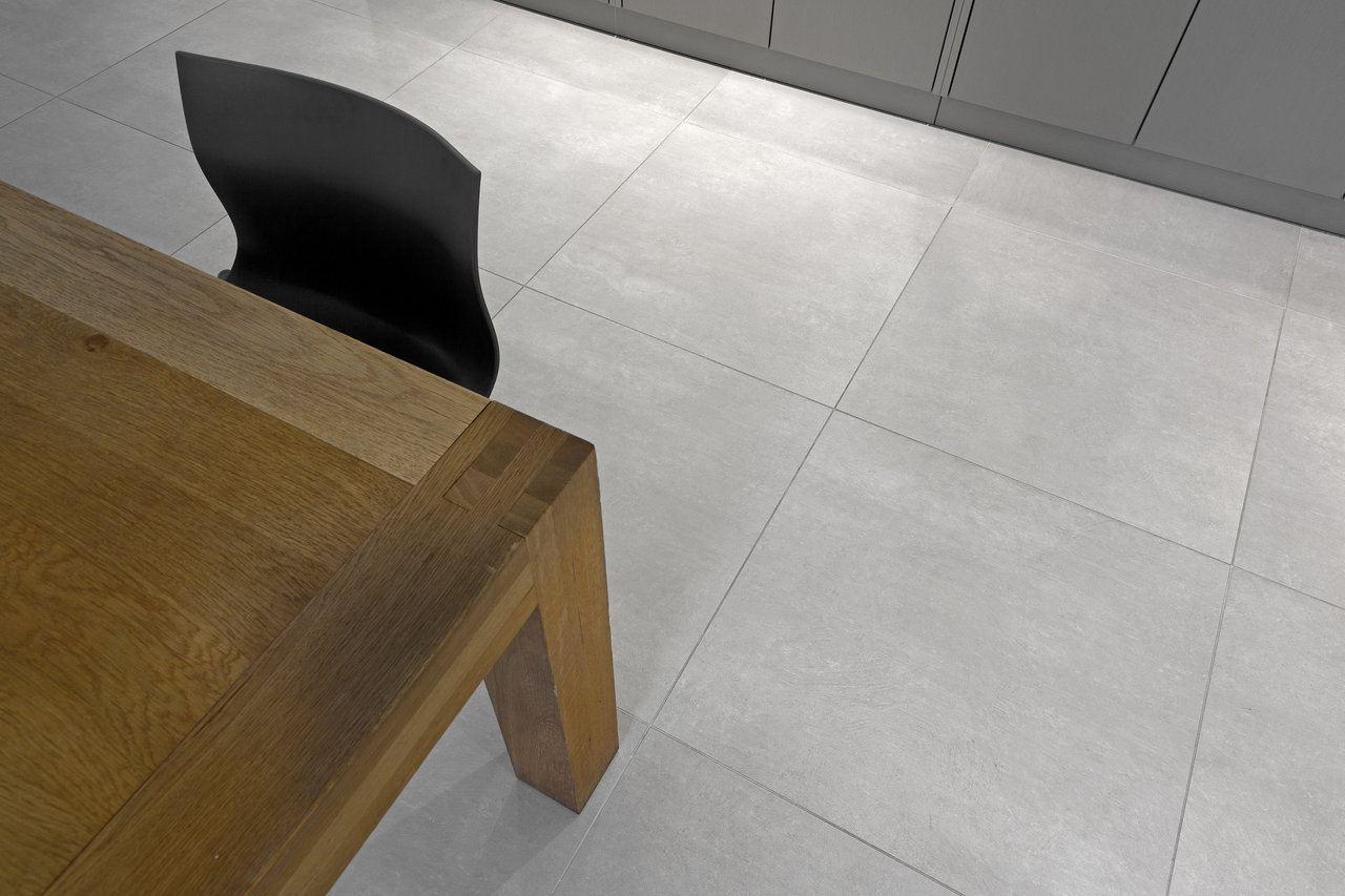 Modern light grey large-format floor tiles in a living room.