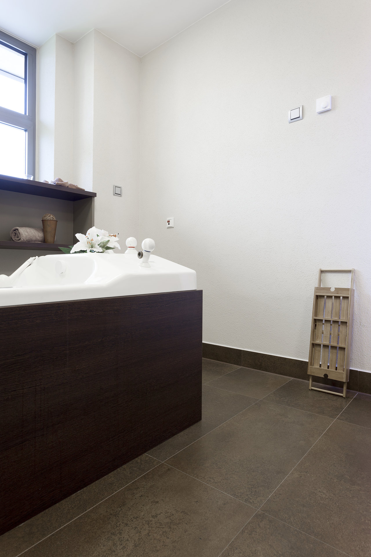 High-quality dark brown floor tiles in a modern bathroom.
